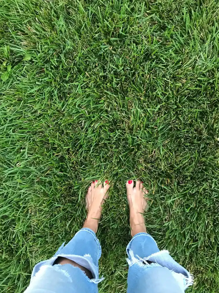 Bare feet on a green lawn